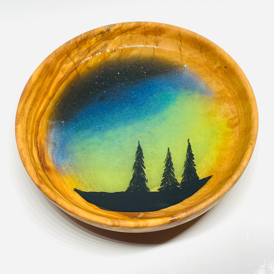 handmade jewelry, Minnesota local wood and resin artist. Northern lights, winter forest, pine tree, hand painted, olive wood bowl with glow-in-the-dark fluorescent green resin ring trinket bowl.