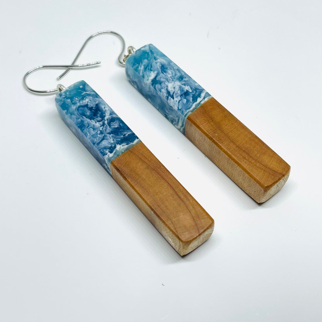 handmade jewelry, Minnesota local wood and resin artist. Ocean waves blue resin with maple wood, nickel free dangle earrings