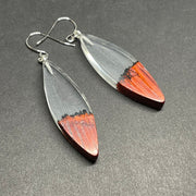 Earrings handmade with clear resin and live edge, burnt African padauk wood, shaped in canoe slivers.