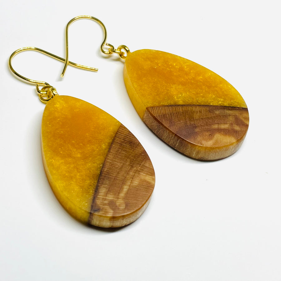 Handmade jewelry in Minnesota. Made with maple wood and golden honey resin, teardrop shaped earrings.