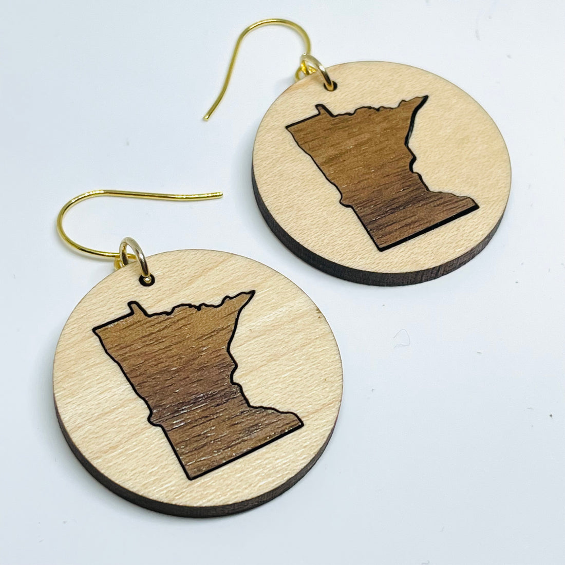 Minnesota local wood and resin artist. laser cut maple wood with walnut inlay, nickel free dangle earrings circle shaped with MN State cutout.