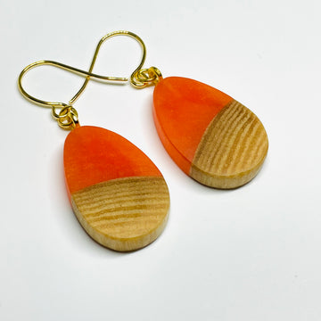 Handmade in Minnesota. Maple wood and orange resin tiny pod shaped earrings.