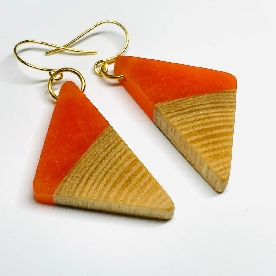 Jewelry handmade in Minnesota. Earrings made of maple wood and orange resin.