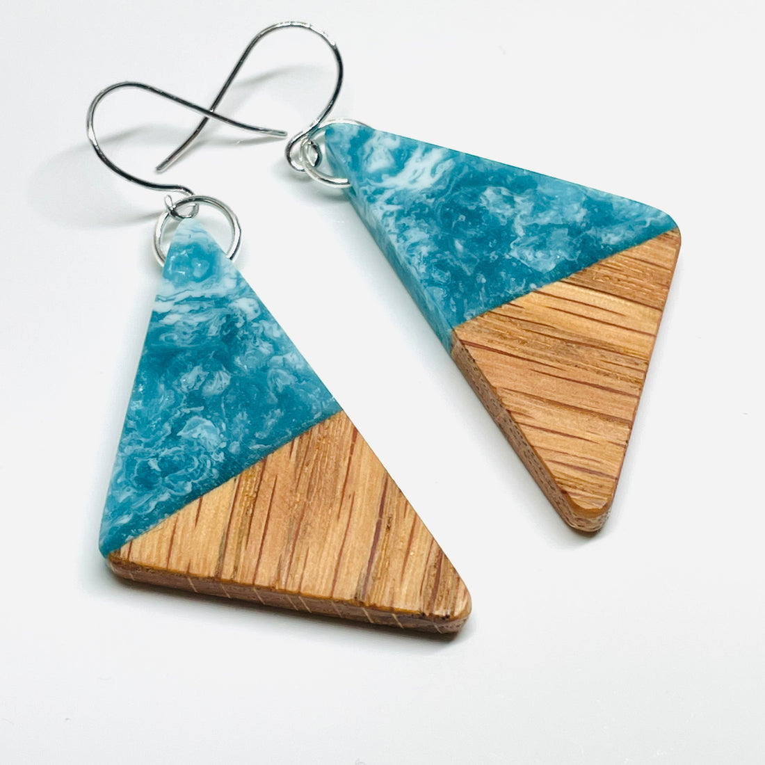 handmade jewelry, Minnesota local wood and resin artist. Ocean waves blue and green resin with white oak wood, nickel free dangle earrings triangle shaped