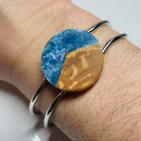 handmade jewelry, Minnesota local wood and resin artist. Ocean waves blue resin with maple wood, platinum plated bracelet