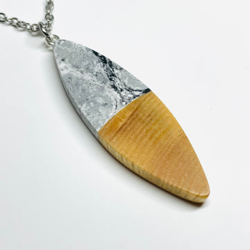 Handmade jewelry in Minnesota. Made from maple wood with black and white resin, large sliver shaped pendant/necklace.