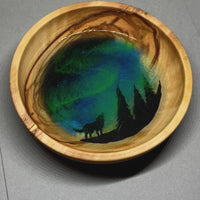 handmade jewelry, Minnesota local wood and resin artist. Northern lights, winter forest, timberwolves, pine trees, hand painted, olive wood bowl with glow-in-the-dark fluorescent green resin ring trinket bowl.