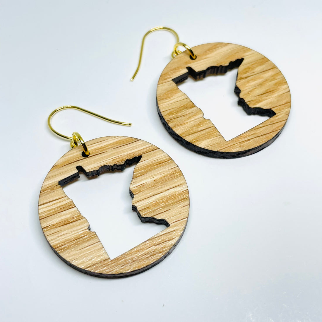 Minnesota local wood and resin artist. laser cut red oak wood, nickel free dangle earrings circle shaped with MN State cutout.