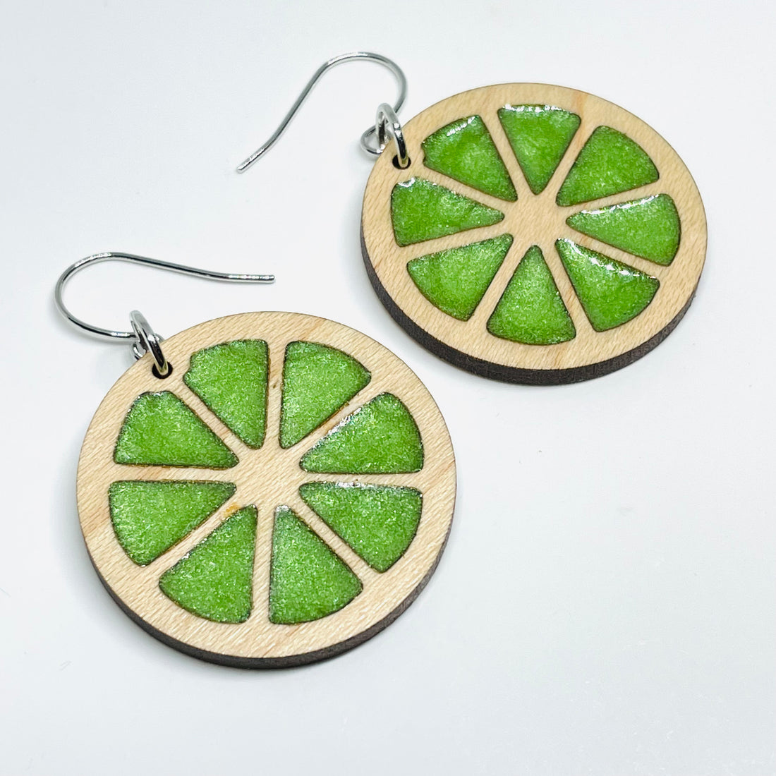 Laser Cut earrings with lime green resin. , Minnesota local wood and resin artist. Maple wood, nickel free dangle earrings citrus slice circle shaped
